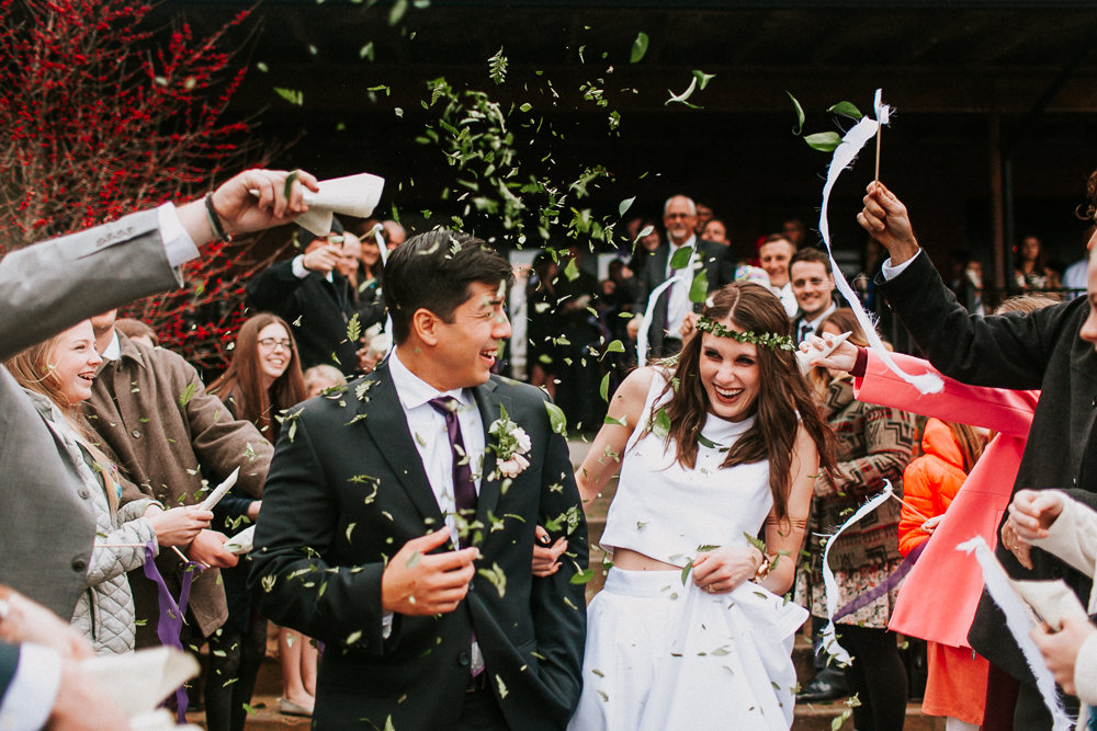 Bride And Groom Having Sustainable Wedding Send-Off With Leaves