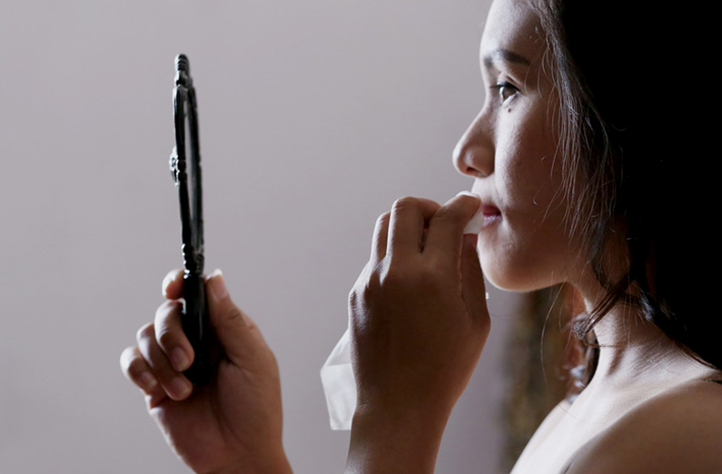 Wedding Makeup - Woman Looking In A Hand Mirror And Dabbing Lipstick