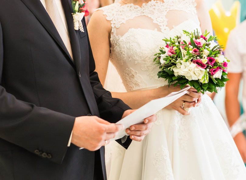 couple holding marriage license